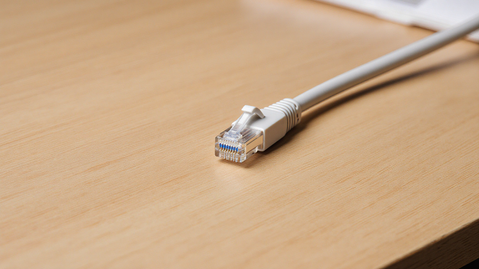 Disconnected network cable beside a closed laptop